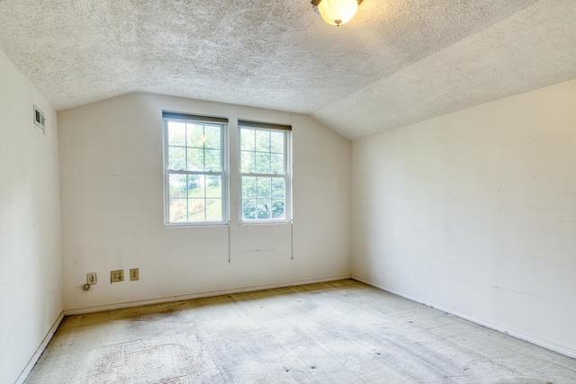 bonus room featuring visible vents, a textured ceiling, carpet floors, and vaulted ceiling