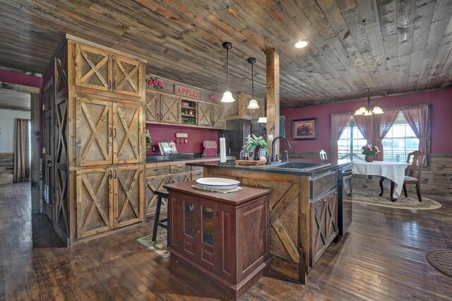kitchen featuring dark wood-style flooring, dark countertops, a sink, wooden ceiling, and an inviting chandelier
