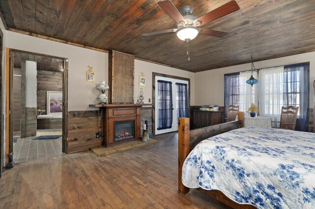 bedroom with a glass covered fireplace, wood ceiling, and wood finished floors