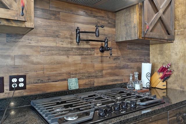 details with dark countertops and black gas stovetop