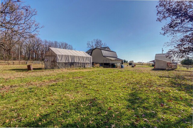 view of yard with a barn and an outbuilding