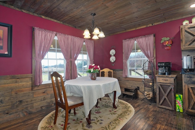 dining area featuring plenty of natural light, a wainscoted wall, and a chandelier