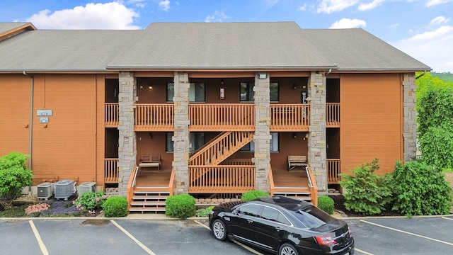 161 Avondale Dr Unit 11, Branson, MO 65616 - view of building exterior with stairs, uncovered parking, and cooling unit