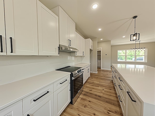 3875 E Dehaven Ln, Fair Grove, MO 65648 - kitchen with range with electric cooktop, under cabinet range hood, light wood-style floors, white cabinets, and recessed lighting