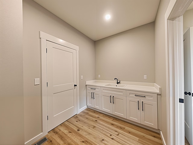 3875 E Dehaven Ln, Fair Grove, MO 65648 - laundry room featuring a sink and light wood finished floors