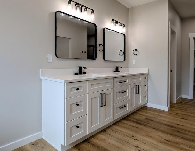 3875 E Dehaven Ln, Fair Grove, MO 65648 - full bathroom featuring double vanity and wood finished floors