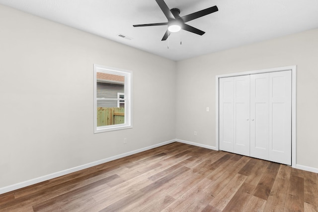 1626 W Lee St, Springfield, MO 65803 - unfurnished bedroom featuring visible vents, a closet, baseboards, a ceiling fan, and light wood-style flooring