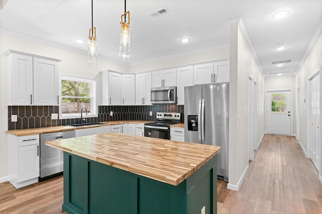 1626 W Lee St, Springfield, MO 65803 - kitchen featuring visible vents, wooden counters, white cabinetry, a sink, and appliances with stainless steel finishes