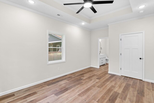1626 W Lee St, Springfield, MO 65803 - unfurnished bedroom featuring crown molding, visible vents, light wood-style floors, recessed lighting, and a tray ceiling