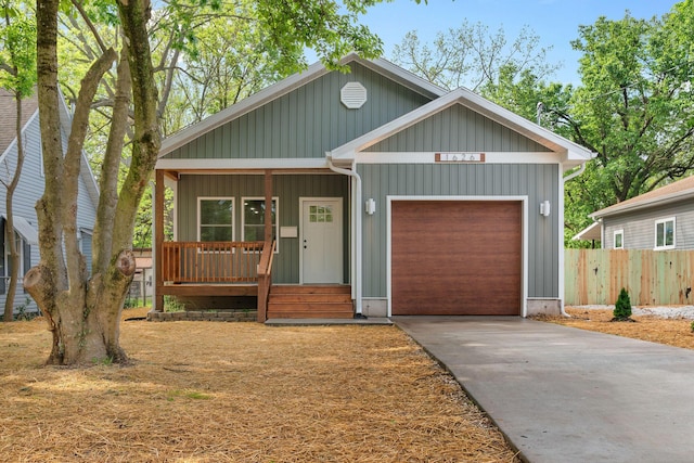 1626 W Lee St, Springfield, MO 65803 - view of front of property with a porch, board and batten siding, driveway, a garage, and fence