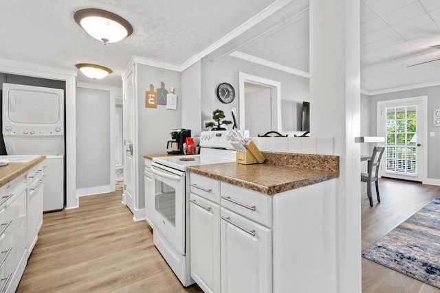 kitchen featuring white cabinets, electric range, stacked washer and dryer, and light wood-style floors
