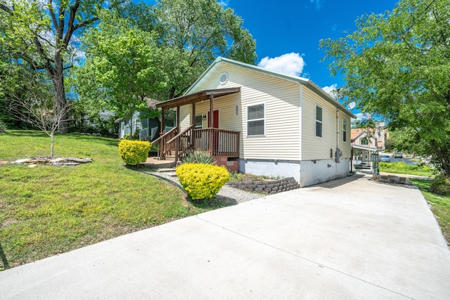bungalow-style home featuring a porch, a front yard, and concrete driveway