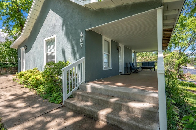 view of home's exterior featuring covered porch and stucco siding
