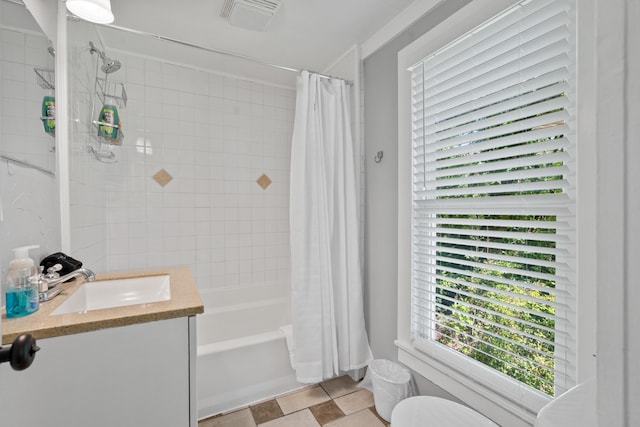 full bathroom with visible vents, shower / tub combo with curtain, toilet, and vanity
