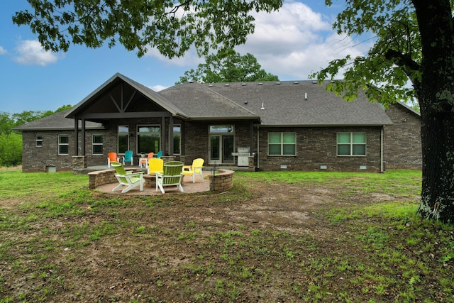 1770 Logan Ridge Rd, Ozark, MO 65721 - rear view of property featuring a shingled roof, an outdoor fire pit, brick siding, a lawn, and a patio