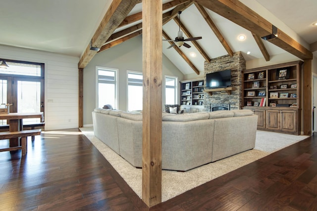 1770 Logan Ridge Rd, Ozark, MO 65721 - living room featuring lofted ceiling with beams, dark wood finished floors, a stone fireplace, and a wealth of natural light