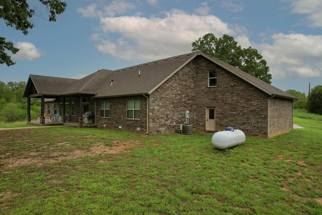 1770 Logan Ridge Rd, Ozark, MO 65721 - view of side of property with cooling unit, a patio, brick siding, a shingled roof, and a yard