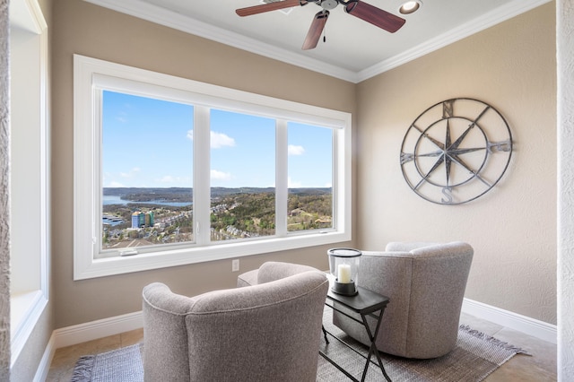 sitting room featuring crown molding, baseboards, and ceiling fan