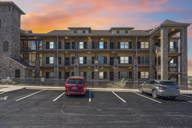 view of building exterior with uncovered parking