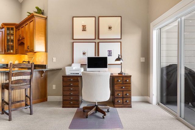 office space featuring baseboards and light carpet