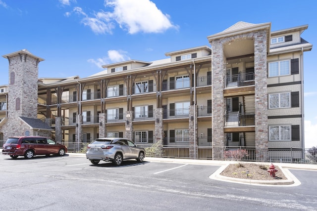 view of property with uncovered parking