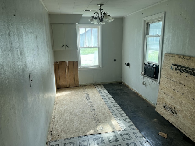 unfurnished dining area featuring a notable chandelier, a wealth of natural light, visible vents, and cooling unit