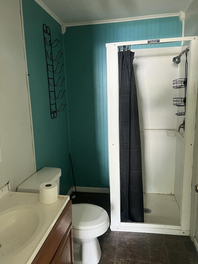 bathroom featuring vanity, toilet, ornamental molding, and a stall shower