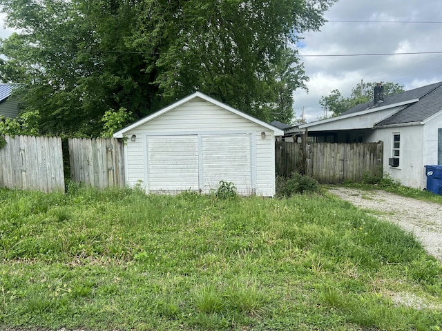 garage with a shed and fence