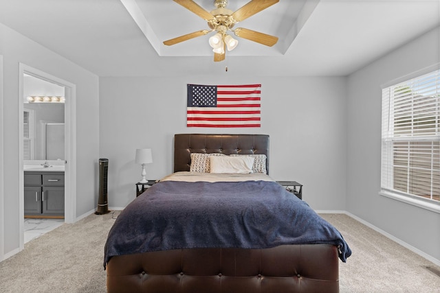 bedroom featuring carpet flooring, baseboards, a sink, and connected bathroom
