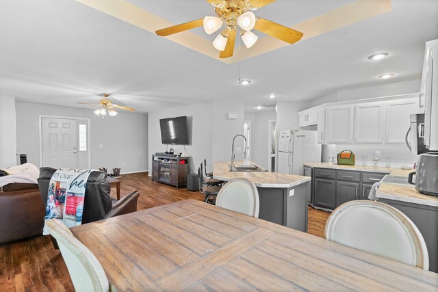 dining room featuring baseboards, recessed lighting, ceiling fan, and wood finished floors