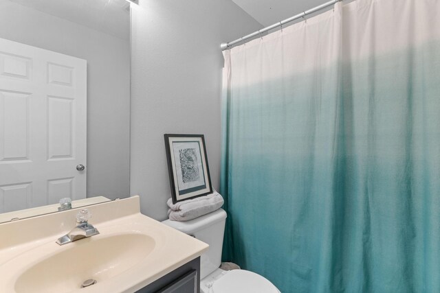 bathroom with vanity, a shower with curtain, and toilet