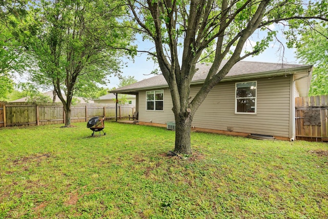 exterior space featuring a fenced backyard and a yard