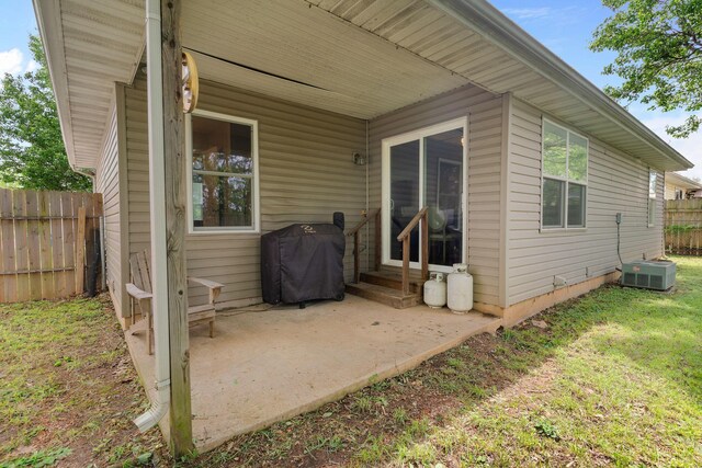 exterior space with central air condition unit, fence, grilling area, and entry steps