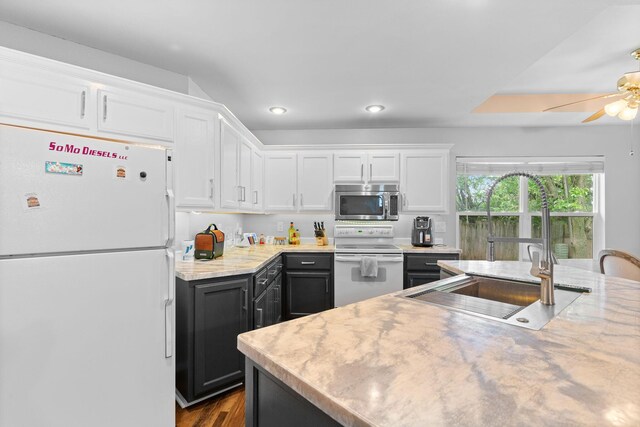 kitchen with a ceiling fan, white appliances, recessed lighting, white cabinets, and a sink