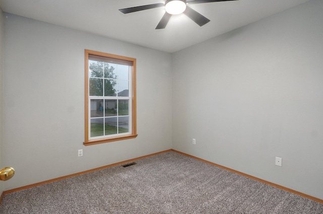 spare room with visible vents, carpet flooring, baseboards, and ceiling fan