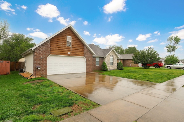 traditional home with brick siding, fence, driveway, and a front yard
