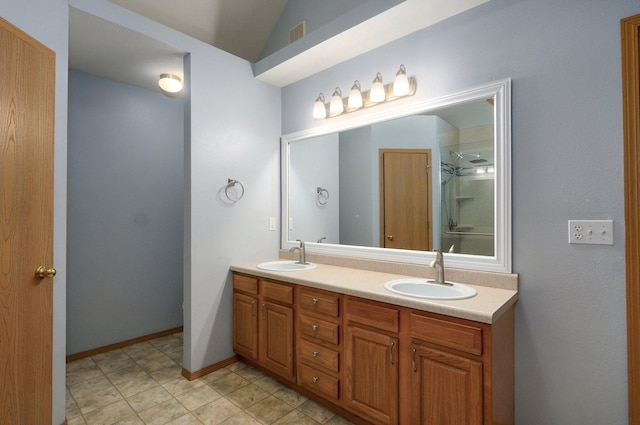 full bath with a sink, a shower with door, double vanity, and visible vents