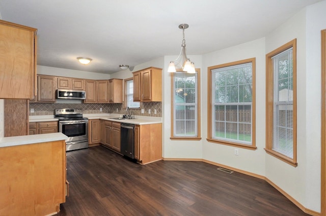 kitchen featuring a sink, light countertops, decorative backsplash, and stainless steel appliances