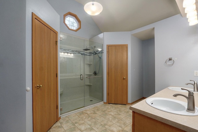 bathroom with double vanity, a sink, and a stall shower