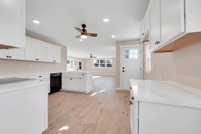 kitchen with a peninsula, ceiling fan, recessed lighting, white cabinetry, and black appliances
