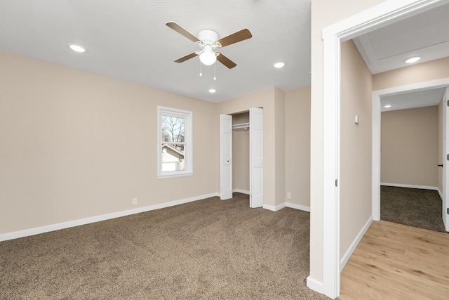 unfurnished bedroom featuring baseboards, light carpet, a closet, and recessed lighting