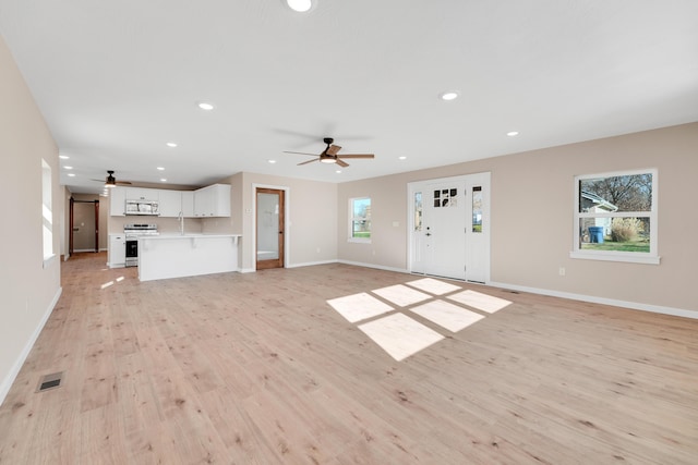 unfurnished living room with light wood-style floors, a ceiling fan, recessed lighting, and visible vents