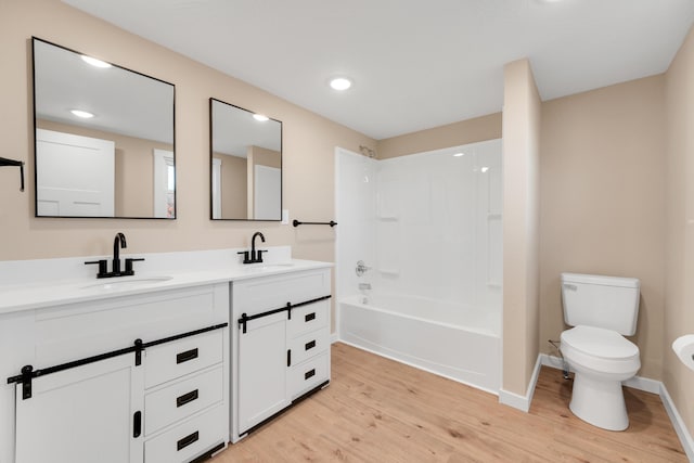 full bathroom featuring a sink, wood finished floors, and toilet