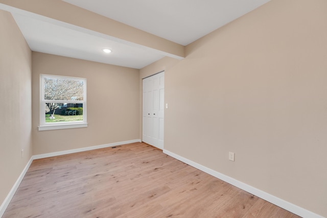 unfurnished room featuring light wood-style floors, recessed lighting, baseboards, and visible vents