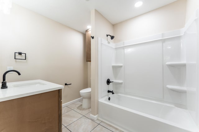 full bathroom with tile patterned flooring, vanity, toilet, baseboards, and washtub / shower combination