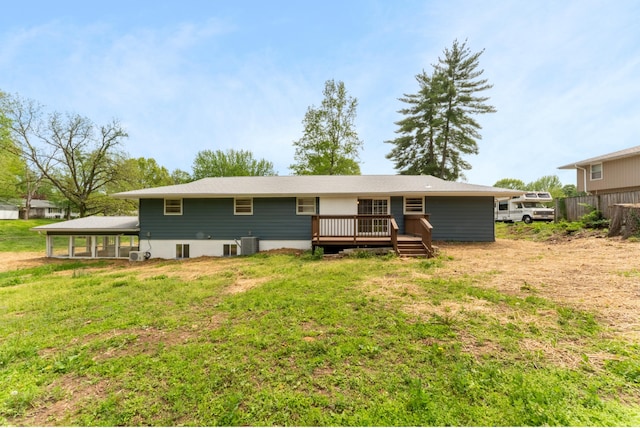 rear view of property with a lawn, fence, central AC unit, and a deck