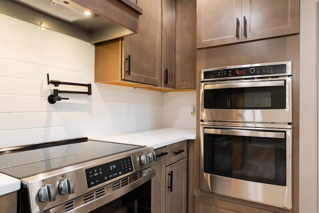 kitchen with light countertops, stainless steel appliances, and tasteful backsplash