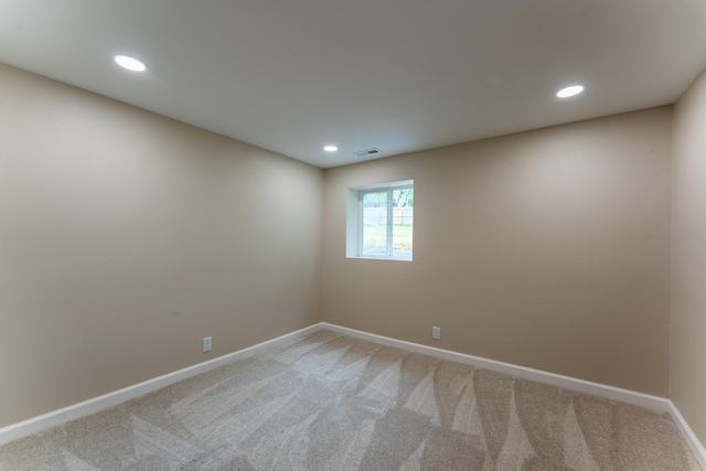 empty room with light colored carpet, baseboards, visible vents, and recessed lighting