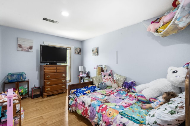 bedroom with visible vents and light wood finished floors