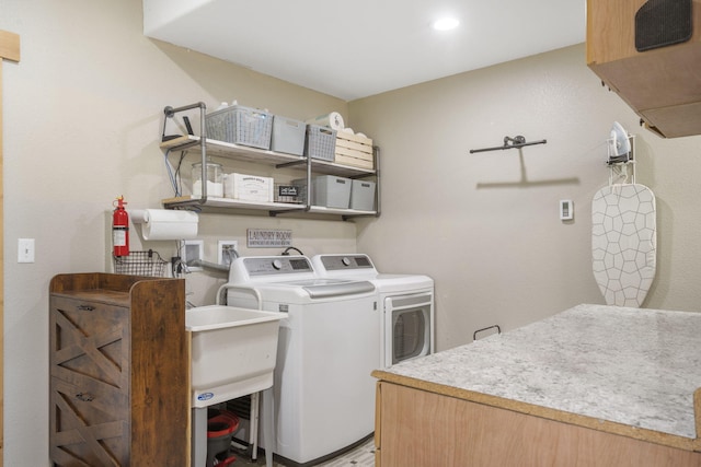 laundry room featuring light wood-type flooring, washer and clothes dryer, and recessed lighting